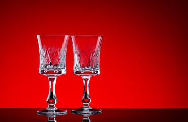 Crystal glasses shot close-up on a red background