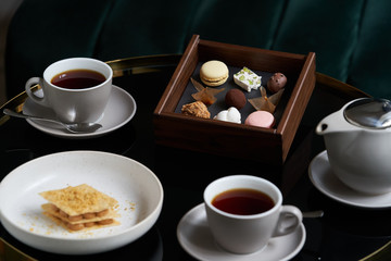 Afternoon tea with cake on restaurant table, close-up.