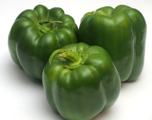 Three green peppers on a white background.