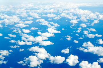 Flying over the sea above the clouds at high altitude in clear weather.