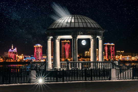 night view with border of china from the waterfront of the city of blagoveschensk. moonlight in a rotunda with a beautigul night sky and moon of background
