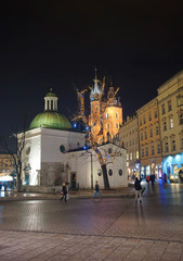 Fototapeta na wymiar St Mary Basilica and Church of St Wojciech in the Main Market Square of the Old City in Krakow in Poland at Christmas in winter