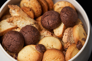 Sweet cookie snack and cappuccino coffee cup on table, close-up
