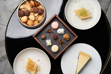  Sweet cookie snack, cake slices and chocolate candy on table, close-up