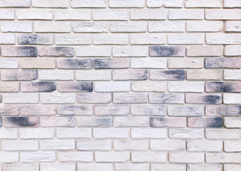 wall is made of white ceramic decorative interior bricks with scorch marks.