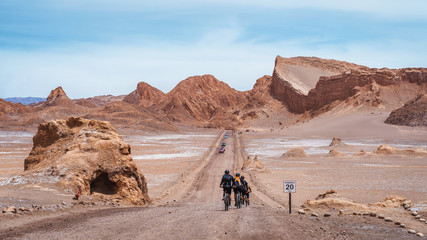 Cyclists at the Moon Valley (Spanish: Valle de la Luna) in the Atacama Desert, northern Chile, South America.