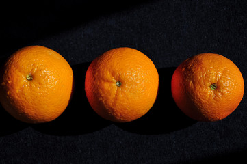 fresh wet oranges on black background,heathy food