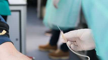 Close-up of a needle, preparation for taking blood from a vein, mobile blood station. Donation...