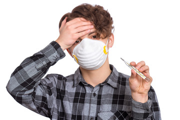 Concept of coronavirus quarantine. Sick Child wearing medical protective mask holds thermometer...