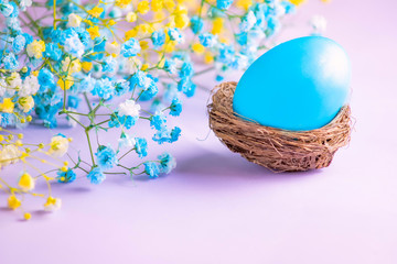 Easter eggs in a basket on table. Copy space.