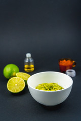 Ingredients for making guacamole with black background. Recipe to prepare a nice guacamole