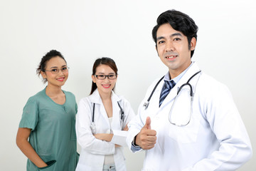 Fototapeta premium Young asian malay chinese male female doctor on white background thumbs up looking at camera