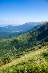 Fototapeta na wymiar Mountains landscape green hills on blue sky background