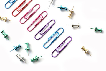 Paper clips on a white background. Stationery. Background.