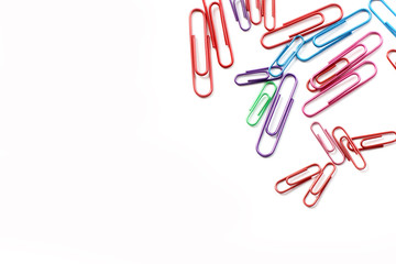 Paper clips on a white background. Stationery. Background