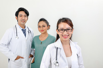 Young asian malay chinese male female doctor on white background smile confident looking at camera