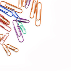 Paper clips on a white background. Stationery. Background