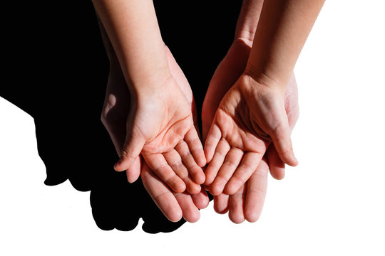 A Closeup Family Photograph Of A Dad Or Father Holding His Infant Boy Or Son's Tiny Open Baby Hand And Fingers In His Palm.