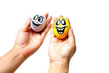 Perfect colorful handmade easter eggs with smile eggs in human hand isolated on a white background. Easter day concepts. Funny decoration. Happy Easter.