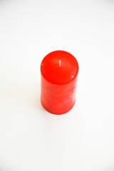 red wax candle on a white background.