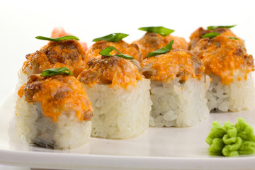 Japanese Cuisine - Appetizing Salmon Sushi Set. Philadelphia Sushi Roll - Maki Sushi with Philadelphia Cheese inside on mirror black background. Smoked salmon rolls served on a plate