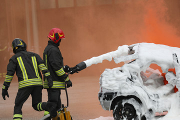 firefighters extinguishing the fire with the foaming agent