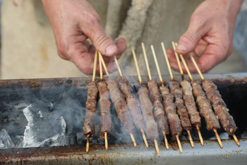 cooking  lamb and mutton skewers called ARROSTICINI in Italian a