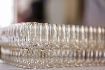 Empty glasses for wine and champagne in a row at the banquet table