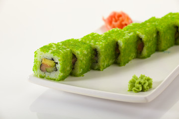 Japanese Cuisine - Appetizing Salmon Sushi Set. Philadelphia Sushi Roll - Maki Sushi with Philadelphia Cheese inside on mirror black background. Smoked salmon rolls served on a plate