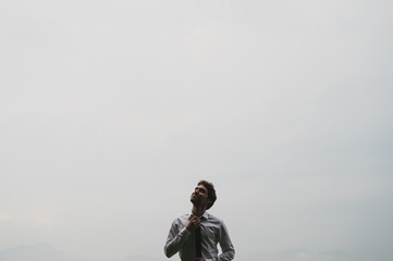 Young businessman loosening his tie