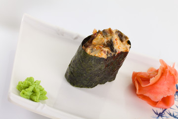 Japanese Cuisine - Appetizing Salmon Sushi Set. Philadelphia Sushi Roll - Maki Sushi with Philadelphia Cheese inside on mirror black background. Smoked salmon rolls served on a plate