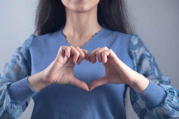 woman hand heart sign