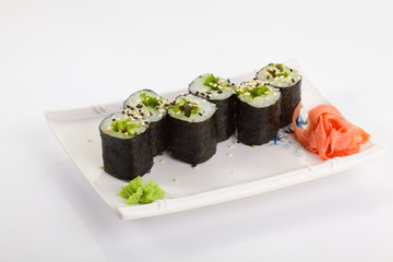 Japanese Cuisine - Appetizing Salmon Sushi Set. Philadelphia Sushi Roll - Maki Sushi with Philadelphia Cheese inside on mirror black background. Smoked salmon rolls served on a plate