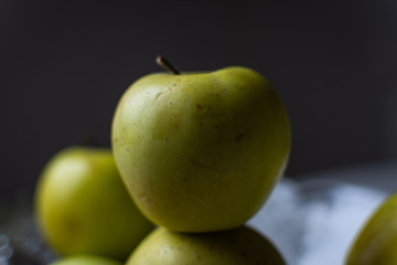 fresh green apples on black background