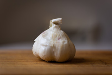 Isolated garlic. Raw garlic with segments isolated on white background, on wooden cutting board