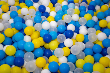 multicolored plastic balls yellow, blue and clear