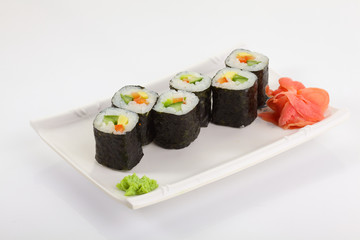 Japanese Cuisine - Appetizing Salmon Sushi Set. Philadelphia Sushi Roll - Maki Sushi with Philadelphia Cheese inside on mirror black background. Smoked salmon rolls served on a plate