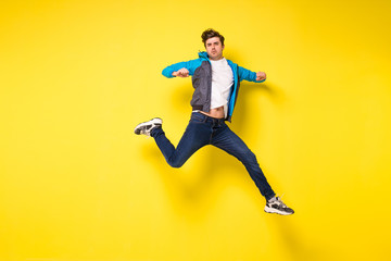 Fototapeta na wymiar jumping man on yellow background