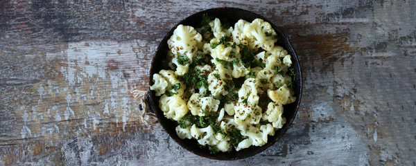 Obraz na płótnie Canvas Baked cauliflower in a pan. Vegan lunch. Healthy diet.