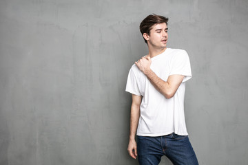 young man standing on a concrete wall