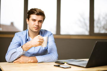 young smart casual man at desk