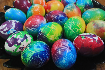 Colorful Easter eggs placed on black plate