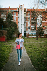  A beautiful young caucasian girl with a notebook in the park