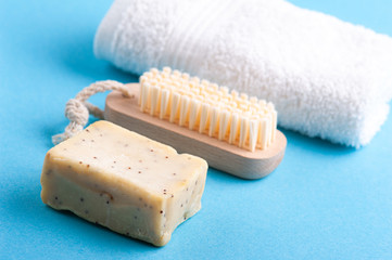 soap, white towel and wooden brush