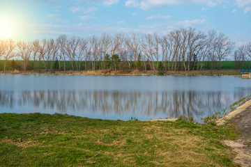 Old water reservoir with trees and sky in the spring