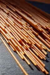 Closeup of spaghetti on slate plate. Macro, shallow DOF.
