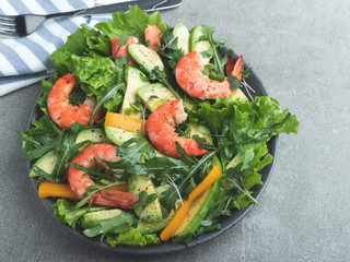 Fresh vegetarian green salad with avocado, shrimp and arugula