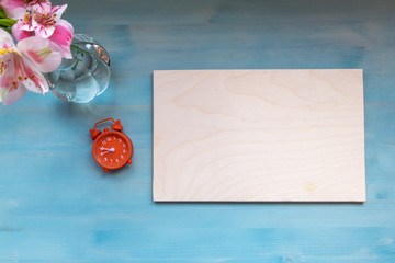 Mock up blue with flowers and o'clock. top view.