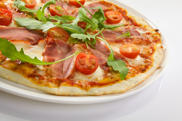 Flatlay of Italian pizza on wooden background. Rustic homemade pizzas with salami, bacon,  cheese, eggs and raw vegetables on shabby wooden background. Healthy vegetarian fungi pizza