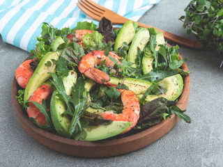 Fresh vegetarian green salad with avocado, shrimp and arugula